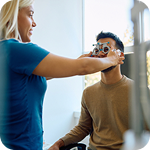 Optometrist checks her client’s vision with special equipment